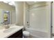 Bathroom with white tile, bathtub, and a single vanity at 8199 Varenna Dr, Sarasota, FL 34231