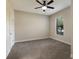Simple bedroom with carpet, neutral walls, and a ceiling fan at 8199 Varenna Dr, Sarasota, FL 34231