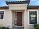 Dark brown front door with sidelights and a welcoming entryway at 8199 Varenna Dr, Sarasota, FL 34231