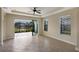 Bright Gathering room with tile floors, sliding glass doors, and lake view at 8199 Varenna Dr, Sarasota, FL 34231