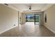 Bright Gathering room with tile floors, sliding glass doors, and lake view at 8199 Varenna Dr, Sarasota, FL 34231