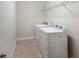 Laundry room with washer, dryer, and overhead shelving at 8199 Varenna Dr, Sarasota, FL 34231