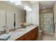Double vanity bathroom with granite countertop and shower at 8224 Varenna Dr, Sarasota, FL 34231