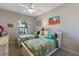 Twin bedroom with white furniture and tropical bedding at 8224 Varenna Dr, Sarasota, FL 34231