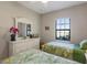 Twin bedroom with white dresser and window view at 8224 Varenna Dr, Sarasota, FL 34231