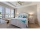 Main bedroom with white headboard bed, window shutters and side tables at 8224 Varenna Dr, Sarasota, FL 34231