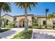 Community clubhouse entrance with landscaping and palm trees at 8224 Varenna Dr, Sarasota, FL 34231