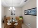 Bright dining room with a glass-top table and wicker chairs at 8224 Varenna Dr, Sarasota, FL 34231