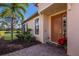 Home entrance with a brown door and decorative plants at 8224 Varenna Dr, Sarasota, FL 34231