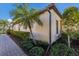 Landscaped walkway alongside a tan home with a palm tree at 8224 Varenna Dr, Sarasota, FL 34231