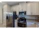 Kitchen boasts stainless steel appliances and granite countertops at 8224 Varenna Dr, Sarasota, FL 34231