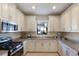 Bright kitchen with white cabinets, granite countertops, and stainless steel appliances at 8224 Varenna Dr, Sarasota, FL 34231