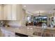 Kitchen with granite countertop island, stainless steel appliances, and view to Gathering room at 8224 Varenna Dr, Sarasota, FL 34231