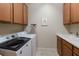 Laundry room with washer, dryer, and cabinets at 8224 Varenna Dr, Sarasota, FL 34231