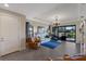 Spacious living room with a blue rug, leather chairs, and sliding glass doors at 8224 Varenna Dr, Sarasota, FL 34231