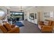 Living room with leather armchairs, a sofa, and a large TV at 8224 Varenna Dr, Sarasota, FL 34231