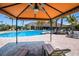 Resort-style pool with lounge chairs and shaded seating at 8224 Varenna Dr, Sarasota, FL 34231