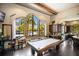 Recreation room with pool table, kitchen, and comfortable seating at 8224 Varenna Dr, Sarasota, FL 34231