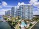 Aerial view of waterfront property with pool and lush landscaping at 888 Blvd Of The Arts # 1408, Sarasota, FL 34236