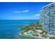 Aerial view of waterfront highrise condo building with pool and marina at 888 Blvd Of The Arts # 1408, Sarasota, FL 34236