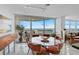 Modern dining room with glass table and balcony access at 888 Blvd Of The Arts # 1408, Sarasota, FL 34236