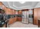 Modern kitchen with stainless steel appliances and wood cabinets at 888 Blvd Of The Arts # 1408, Sarasota, FL 34236