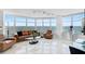 Spacious living room with bay windows, leather furniture, and marble floors at 888 Blvd Of The Arts # 1408, Sarasota, FL 34236