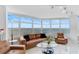 Bright living room with panoramic water views and comfortable seating at 888 Blvd Of The Arts # 1408, Sarasota, FL 34236