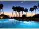 Relaxing pool area with palm trees at sunset at 888 Blvd Of The Arts # 1408, Sarasota, FL 34236