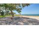 Relaxing waterfront deck with seating and shade under a large tree at 888 Blvd Of The Arts # 1408, Sarasota, FL 34236