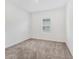 Simple bedroom with carpeted floor and single window at 10611 Ladybug Cv, Parrish, FL 34219