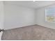 Bright bedroom with grey carpet and large window at 10611 Ladybug Cv, Parrish, FL 34219