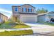 Two-story house with neutral siding, two-car garage, and landscaped yard at 10611 Ladybug Cv, Parrish, FL 34219