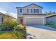 Two-story house with neutral siding, two-car garage, and landscaped yard at 10611 Ladybug Cv, Parrish, FL 34219