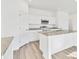 Modern kitchen with white cabinets, granite countertops, and island at 10611 Ladybug Cv, Parrish, FL 34219