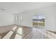 Living room with vinyl plank flooring, sliding glass doors and view of a lake at 10611 Ladybug Cv, Parrish, FL 34219