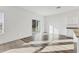 Open concept living space with vinyl plank flooring and sliding glass doors leading to a patio at 10611 Ladybug Cv, Parrish, FL 34219