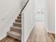 Modern staircase with carpeted steps and wood flooring at 10611 Ladybug Cv, Parrish, FL 34219