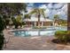 Relaxing community pool with a pool house and lounge area at 10611 Ladybug Cv, Parrish, FL 34219