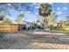 Home's backyard with grill, smoker, and gravel driveway at 1100 27Th W Ave, Palmetto, FL 34221