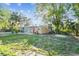 Large backyard with grassy area and partial view of guest house at 1100 27Th W Ave, Palmetto, FL 34221