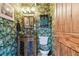 Small bathroom with tropical wallpaper and vanity at 1100 27Th W Ave, Palmetto, FL 34221