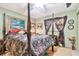 Main bedroom with four-poster bed and floral bedding at 1100 27Th W Ave, Palmetto, FL 34221