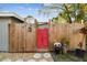 Red gate entrance to the backyard at 1100 27Th W Ave, Palmetto, FL 34221