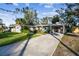 Home exterior with a long driveway and lush landscaping at 1100 27Th W Ave, Palmetto, FL 34221