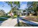 Ranch style home with American flag and driveway at 1100 27Th W Ave, Palmetto, FL 34221