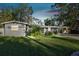 Gray house with landscaped lawn, driveway and carport at 1100 27Th W Ave, Palmetto, FL 34221
