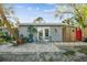 Gray guest house with double doors, patio, and red gate at 1100 27Th W Ave, Palmetto, FL 34221