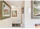 Hallway with framed artwork and carpet runner leading to bedrooms at 1100 27Th W Ave, Palmetto, FL 34221
