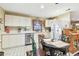 Kitchen features white cabinets, stainless steel appliances, and tile floor at 1100 27Th W Ave, Palmetto, FL 34221